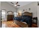 Cozy main bedroom with hardwood floors, ceiling fan, and an ensuite bathroom access at 10119 Bayard Ct, Orlando, FL 32836