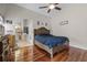 Comfortable main bedroom with hardwood floors, a ceiling fan, and an ensuite bathroom at 10119 Bayard Ct, Orlando, FL 32836