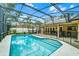 Backyard pool area featuring a screened enclosure, safety fence and outdoor seating at 10119 Bayard Ct, Orlando, FL 32836