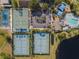 Aerial view featuring community basketball and tennis courts, parking lot, and playground at 1018 Oceanbreeze Ct, Orlando, FL 32828