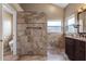 Well-lit bathroom with dual sinks and tiled walk-in shower at 1018 Oceanbreeze Ct, Orlando, FL 32828