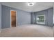 Spacious bedroom with neutral carpet, blue walls, walk-in closet, and a window that allows plenty of natural light at 1018 Oceanbreeze Ct, Orlando, FL 32828