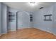Room with light blue walls, built-in shelving, and wood-look floors at 1018 Oceanbreeze Ct, Orlando, FL 32828