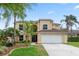 Charming two-story home with a well-manicured lawn and attached two car garage at 1018 Oceanbreeze Ct, Orlando, FL 32828