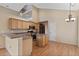 Open kitchen with island, stainless appliances, light wood cabinets and breakfast nook at 1018 Oceanbreeze Ct, Orlando, FL 32828