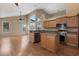 Open kitchen featuring stainless steel appliances, light wood cabinets, and island with breakfast bar at 1018 Oceanbreeze Ct, Orlando, FL 32828