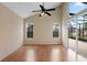 Bright living room with laminate floors and sliding glass doors to screened-in patio at 1018 Oceanbreeze Ct, Orlando, FL 32828