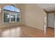 Sunlit living room with hardwood floors and large windows overlooking the backyard at 1018 Oceanbreeze Ct, Orlando, FL 32828