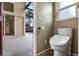 Powder room featuring toilet and view of pool from sliding glass door at 1018 Oceanbreeze Ct, Orlando, FL 32828