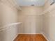 Walk-in closet with wooden floors and built-in metal shelving at 1018 Oceanbreeze Ct, Orlando, FL 32828