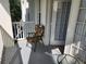 A cozy balcony with a chair and table offers a private outdoor space with access to the interior through white-framed doors at 1021 Siena Park E Blvd # 301, Celebration, FL 34747