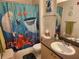 A charming bathroom with a whimsical Finding Nemo shower curtain and complementary decor at 1021 Siena Park E Blvd # 301, Celebration, FL 34747