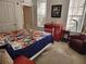 Cozy bedroom with a colorful bedspread, ample natural light, and a comfortable seating area at 1021 Siena Park E Blvd # 301, Celebration, FL 34747