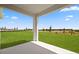 Covered porch offering serene views of the spacious and beautifully maintained backyard at 1026 Vineyard Ridge Rd, Minneola, FL 34715