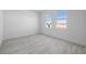Bright and airy bedroom featuring neutral walls, two windows, and stylish tile flooring at 1026 Vineyard Ridge Rd, Minneola, FL 34715