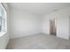 Bright bedroom featuring neutral carpet, white walls, and an ensuite bathroom at 1026 Vineyard Ridge Rd, Minneola, FL 34715