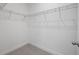 Walk-in closet featuring wire shelving and neutral carpet flooring at 1026 Vineyard Ridge Rd, Minneola, FL 34715