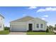 Charming single-story home with a two-car garage, well-manicured lawn, and inviting entryway at 1026 Vineyard Ridge Rd, Minneola, FL 34715