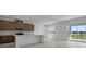 Open-concept kitchen and dining area with stainless steel appliances and sliding glass doors to the backyard at 1026 Vineyard Ridge Rd, Minneola, FL 34715