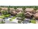 Aerial view of townhomes with tile roofs and well-manicured lawns, showcasing the community's lush landscaping and layout at 10743 Belfry Cir, Orlando, FL 32832