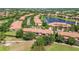 Aerial view of well-maintained townhomes surrounding a beautiful lake and golf course at 10743 Belfry Cir, Orlando, FL 32832