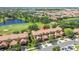 Beautiful aerial view of townhomes with tile roofs and a golf course with water features at 10743 Belfry Cir, Orlando, FL 32832