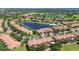 Picturesque aerial view showcasing townhomes surrounding a lake, near a golf course and a pool at 10743 Belfry Cir, Orlando, FL 32832