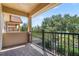Outdoor balcony with brick floor, black iron railings, and view of trees and greenery at 10743 Belfry Cir, Orlando, FL 32832