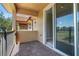 Outdoor balcony with brick floor and black iron railings, with a view to another bedroom at 10743 Belfry Cir, Orlando, FL 32832