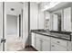 Bathroom with granite countertop, white cabinets, and decorative vanity lighting at 10743 Belfry Cir, Orlando, FL 32832