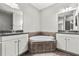 Primary bath featuring soaking tub, dual sinks, vanities with tiled accents at 10743 Belfry Cir, Orlando, FL 32832