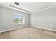 Spacious bedroom featuring neutral paint, carpet, and window with blinds at 10743 Belfry Cir, Orlando, FL 32832