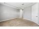 Minimalist bedroom with carpet, featuring tray ceiling and double door closet at 10743 Belfry Cir, Orlando, FL 32832