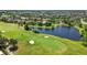 Scenic golf course view featuring lush greenery, sand traps, and a tranquil lake at 10743 Belfry Cir, Orlando, FL 32832