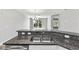 Kitchen sink with granite countertop and views of the dining and back yard at 10743 Belfry Cir, Orlando, FL 32832