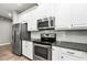 Well-equipped kitchen features stainless steel appliances and white cabinets at 10743 Belfry Cir, Orlando, FL 32832