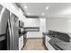 Kitchen featuring stainless steel appliances, granite countertops, and white cabinets at 10743 Belfry Cir, Orlando, FL 32832