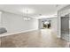 Open-concept living area with a sliding glass door and an elegant chandelier at 10743 Belfry Cir, Orlando, FL 32832