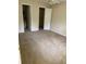 Bedroom featuring neutral carpet, ceiling fan, and two doorways, one to the bathroom and one to the closet at 1089 S Hiawassee Rd # 314, Orlando, FL 32835