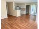 Living room featuring laminate flooring, a partial view of the kitchen, and sliding glass doors to the outside at 1089 S Hiawassee Rd # 314, Orlando, FL 32835