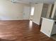 Living room featuring laminate flooring, a ceiling fan, and a breakfast bar between the kitchen and living area at 1089 S Hiawassee Rd # 314, Orlando, FL 32835