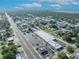 Wide aerial shot showcases a highway lined with commercial properties, stores, and a clear view of the distant lake at 1110 Virginia Ave, St Cloud, FL 34769