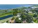 High-angle shot of waterfront area featuring a lake, boat docks, and houses surrounded by trees under a clear sky at 1110 Virginia Ave, St Cloud, FL 34769