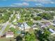 A high-angle shot displays a residential area with a pool and well-maintained lawns under a clear sky with fluffy clouds at 1110 Virginia Ave, St Cloud, FL 34769