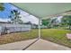 A spacious backyard includes partial fencing and a covered patio area for outdoor relaxation at 1110 Virginia Ave, St Cloud, FL 34769