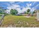 The large backyard has a brick fireplace and a storage shed, great for outdoor activities at 1110 Virginia Ave, St Cloud, FL 34769