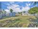 Overiew of expansive backyard featuring lush grass, storage shed, and fencing at 1110 Virginia Ave, St Cloud, FL 34769