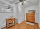 This cozy bedroom features wood-look floors, a ceiling fan, and a light wood dresser at 1110 Virginia Ave, St Cloud, FL 34769