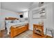 Cozy bedroom with a wooden bed frame, soft blue bedding, and natural light at 1110 Virginia Ave, St Cloud, FL 34769