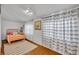 Bright bedroom with hardwood floors, colorful bed frame, and decorative striped curtains at 1110 Virginia Ave, St Cloud, FL 34769